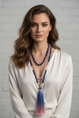 Elegant female model wearing Le Omnia Mala hand-knotted gemstone mala necklace
