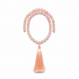 Minimal coral pink mala necklace with blush gemstone beads centered on white background