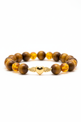 Luxury feminine spiritual bracelet with golden tiger's eye and honey amber beads, side angle view