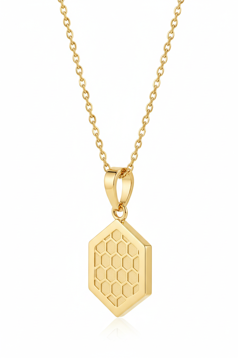 Luxury feminine gold hexagonal pendant necklace with honeycomb engraving, side angle view