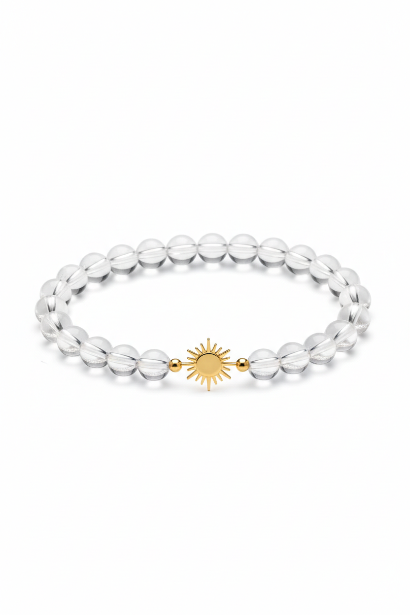Luxury spiritual crystal quartz bracelet with gold sun charm, centered on white background
