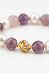 Macro image of Harmony Stone Bracelet natural bead surface texture and gold charm craftsmanship