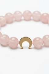 Close-up detail of rose quartz beads and gold crescent moon charm on Calm Soul Bracelet