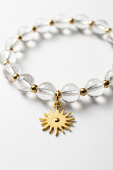 Jewelry close-up of Pure Energy Bracelet showing crystal clarity and gold sun charm detail