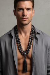 Male model wearing Stone Mala Necklace natural dark gemstone mala draped on neck and chest