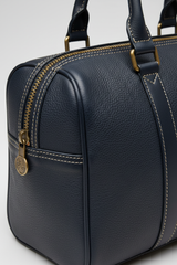 Le Compact Weekender in Navy, portrait leather and zipper macro close-up