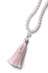 Close-up of Le Opaline Mala opaline bead surface and tassel craftsmanship