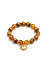 Luxury feminine spiritual bracelet with golden tiger's eye and honey amber beads and gold winged heart charm, front view