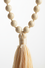 Macro close-up of Le Divine Mala ivory bead texture and handcrafted cord craftsmanship