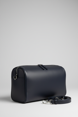 Le Compact Weekender in Navy, portrait side-angle shot with strap