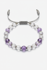 Close-up of Pure Energy Bracelet crystal bead surface with light refractions and handcrafted cord craftsmanship