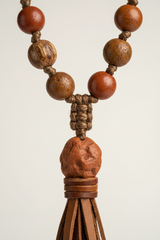 Macro texture shot of Earth Mala Necklace natural earthy bead surface and handcrafted cord craftsmanship