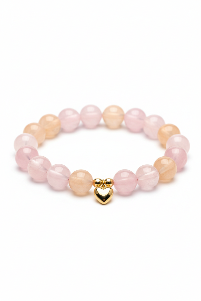 Luxury feminine spiritual bracelet with pastel pink rose quartz and peach aventurine beads and gold heart charm, centered on white background