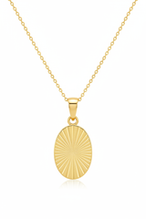 Luxury gold oval pendant necklace with geometric sunburst engraving, front view on white background
