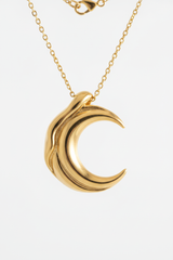 Macro jewelry shot of Le Luna gold moon pendant craftsmanship