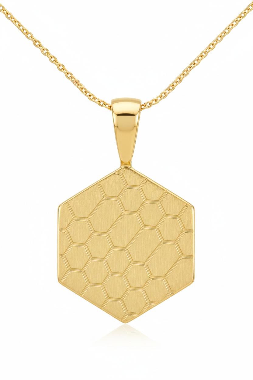 Close-up pendant detail of hexagonal gold pendant with honeycomb engraving on Eternal Glow Necklace