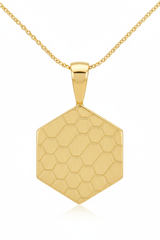 Close-up pendant detail of hexagonal gold pendant with honeycomb engraving on Eternal Glow Necklace