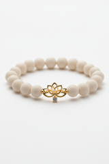 Premium delicate charm detail on Calm Soul Bracelet against neutral cream gemstone beads
