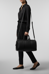 Le Compact Weekender in Black, portrait lifestyle travel model image