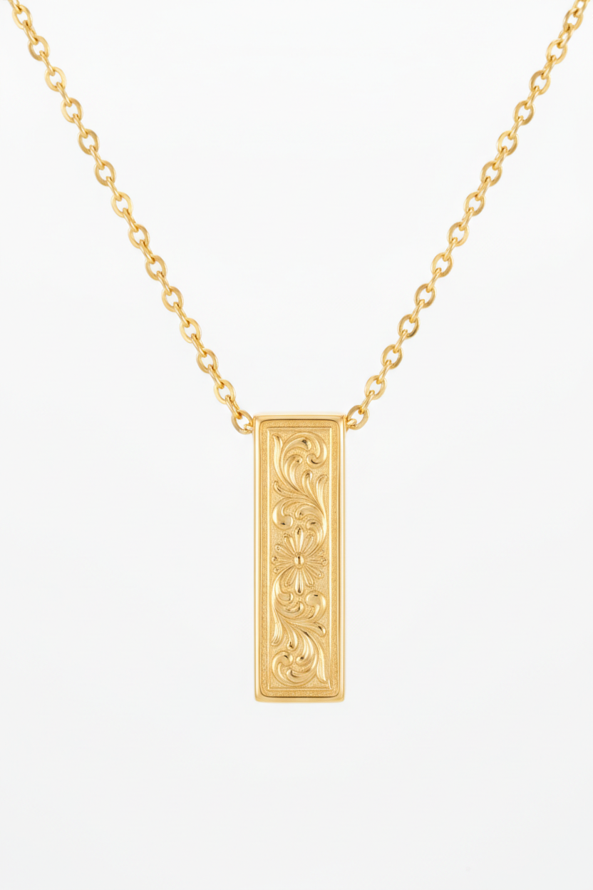 Jewelry macro close-up of Inner Power Necklace showing gold pendant engraving and chain detail