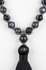 Macro image of Stone Mala Necklace natural gemstone bead surface and handcrafted cord craftsmanship