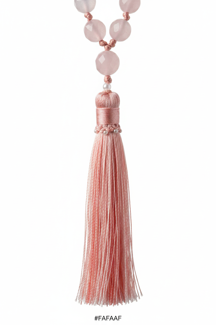 Macro shot of Le Amara Mala elegant silk tassel in soft blush pink tones