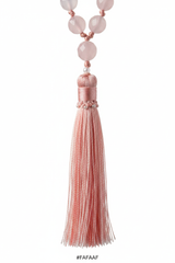Macro shot of Le Amara Mala elegant silk tassel in soft blush pink tones