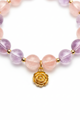 Jewelry close-up of Pure Love Bracelet showing strawberry quartz and amethyst crystal clarity and gold rose charm