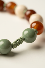 Macro texture shot of Le Zen Mala gemstone bead surface and hand-knotted cord craftsmanship