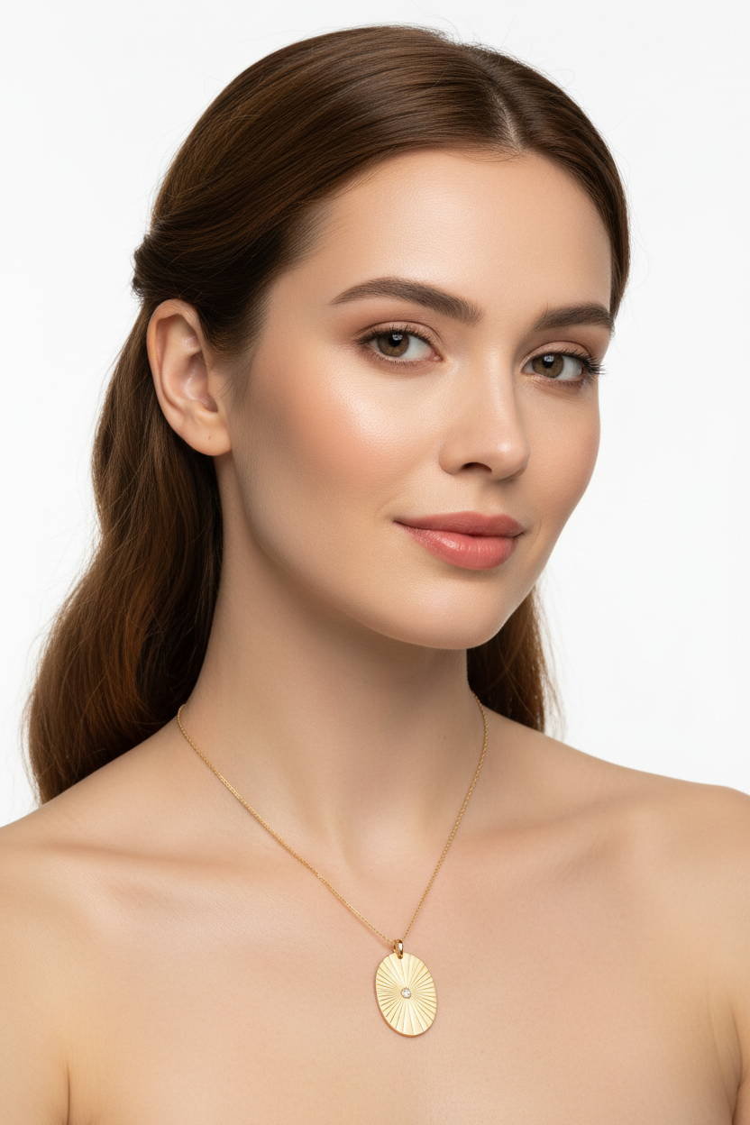 Elegant female model wearing Sacred Light Necklace with oval gold pendant and fine chain