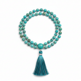 Elegant turquoise mala necklace centered on white background