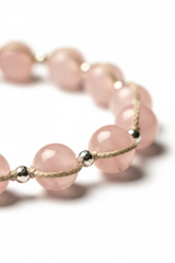 Macro close-up of Le Serenity Mala gemstone bead texture and cord craftsmanship