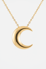 Close-up of Le Luna crescent moon gold pendant