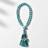 Luxury turquoise mala necklace centered on white background