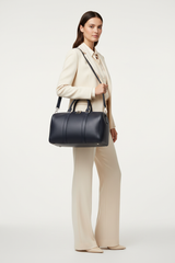 Le Compact Weekender in Navy, portrait lifestyle travel model image