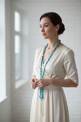 Woman wearing elegant turquoise mala necklace
