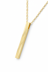 Luxury gold rectangular pendant necklace with engraved texture, diagonal angle view