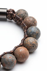 Macro texture shot of Stone Bead Bracelet natural stone bead surface and cord craftsmanship