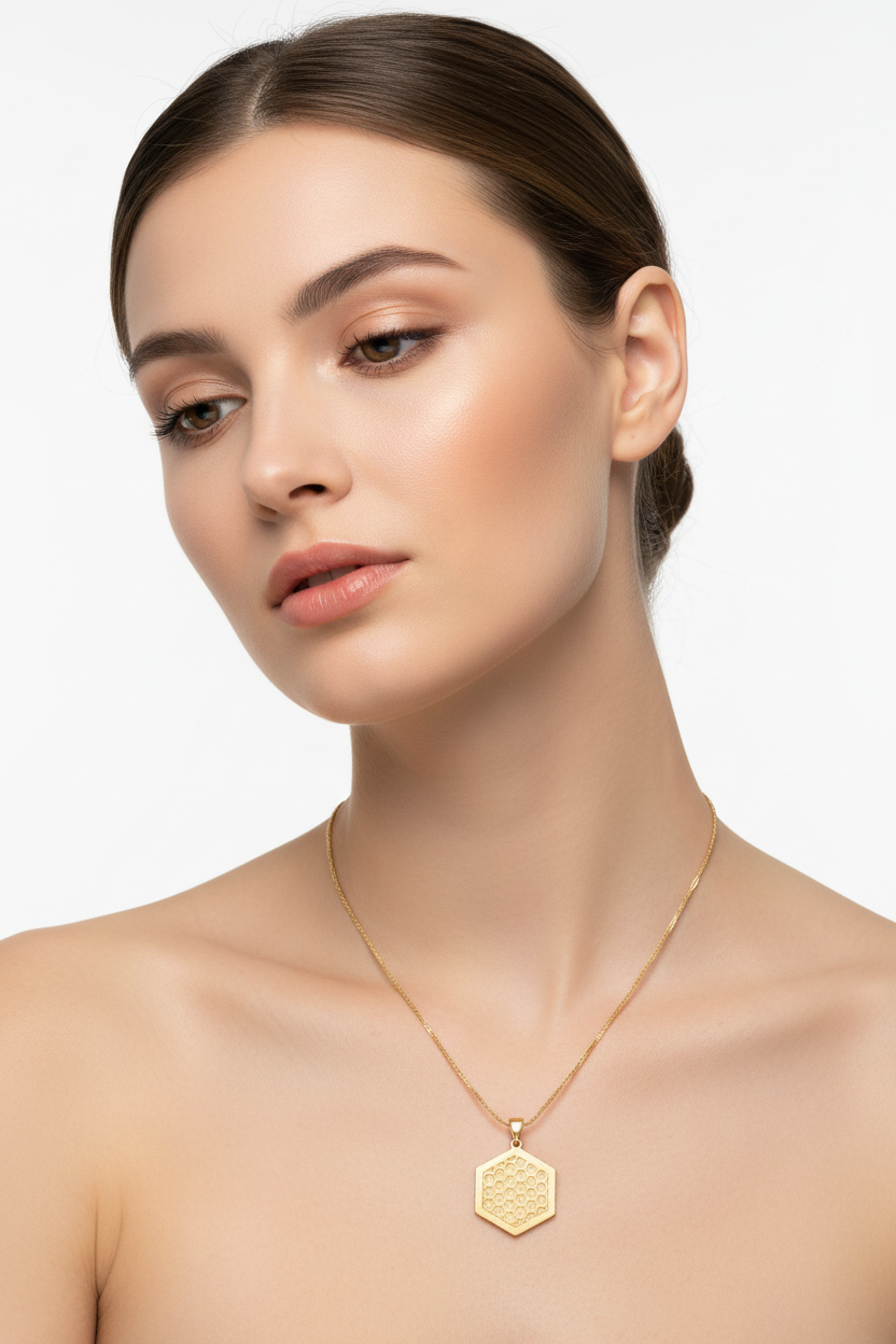 Elegant female model wearing Eternal Glow Necklace with hexagonal gold pendant and fine chain
