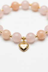 Jewelry macro close-up of Love Energy Bracelet showing pastel bead texture and gold heart charm detail