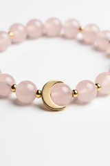 Jewelry macro close-up of Calm Soul Bracelet showing rose quartz bead texture and gold charm