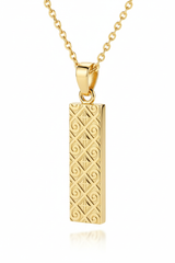 Macro close-up of rectangular gold pendant with engraved texture on Inner Power Necklace