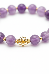 Close-up detail of lavender amethyst beads and gold lotus charm on spiritual bracelet