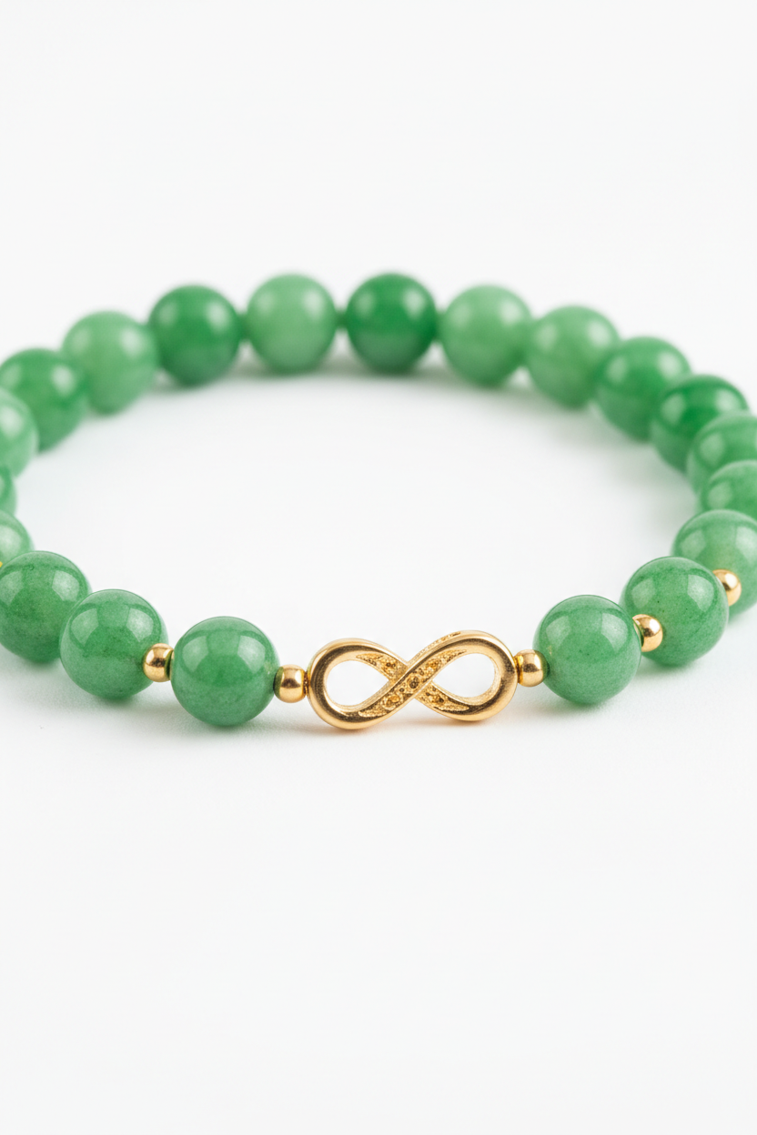 Macro jewelry image of Harmony Stone Bracelet showing jade bead texture and gold infinity charm