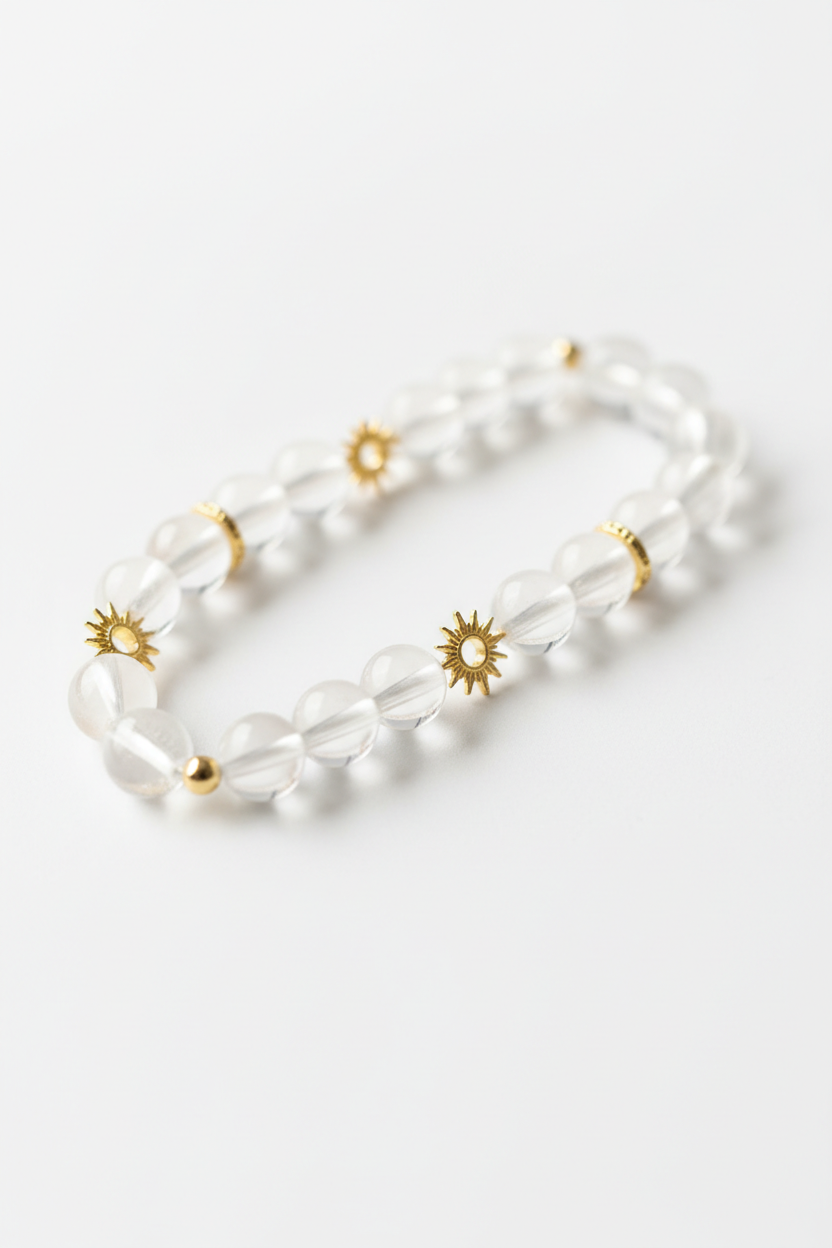 Luxury spiritual crystal quartz bracelet with gold sun charm, diagonal angle view