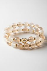 Luxury spiritual bead bracelet with champagne moonstone and cream selenite beads, side angle view